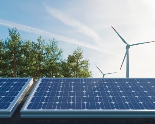 Solar panels and wind turbines illustrating renewable energy for CO₂ reduction.
