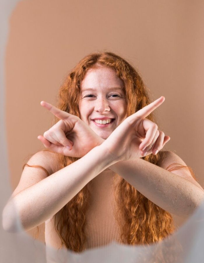 Smiling young woman with glowing skin, representing youthful appearance and healthy glow.